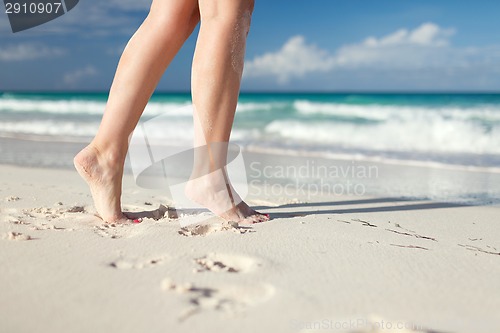 Image of closeup of woman legs on sea shore