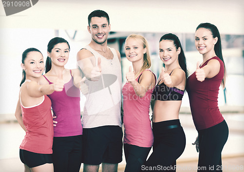 Image of group of people in the gym showing thumbs up