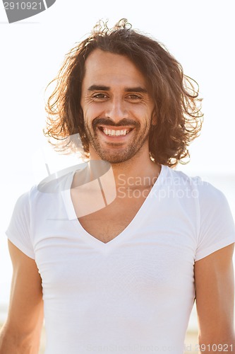 Image of smiling man in white blank shirt outdoors