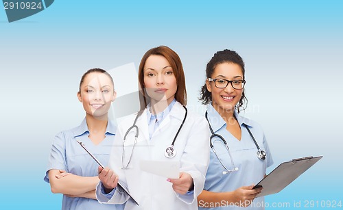 Image of calm female doctor with clipboard