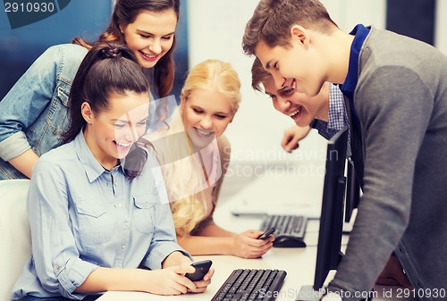 Image of students with computer monitor and smartphones