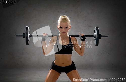 Image of sporty woman exercising with barbell