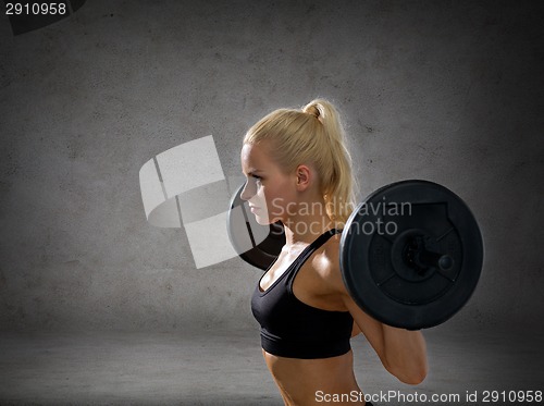 Image of sporty woman exercising with barbell