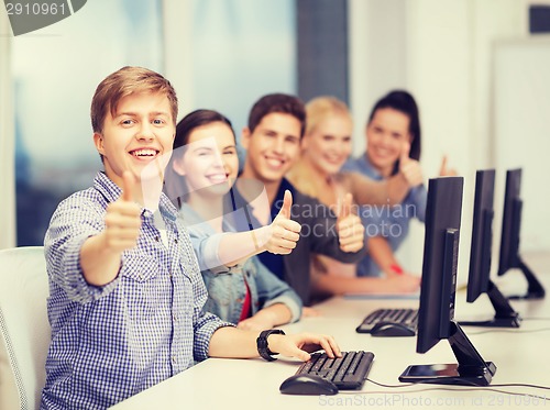 Image of students with computer monitor showing thumbs up