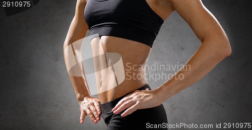 Image of close up of athletic female abs in sportswear