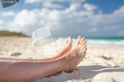 Image of closeup of woman legs on sea shore