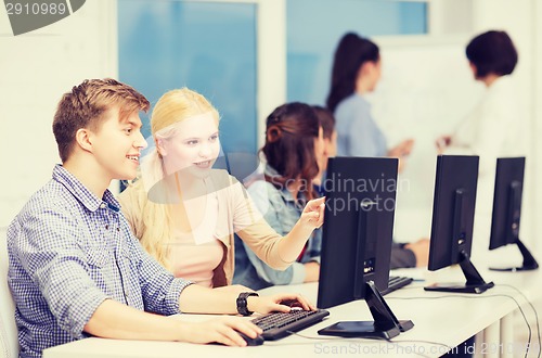 Image of students with computer monitor at school