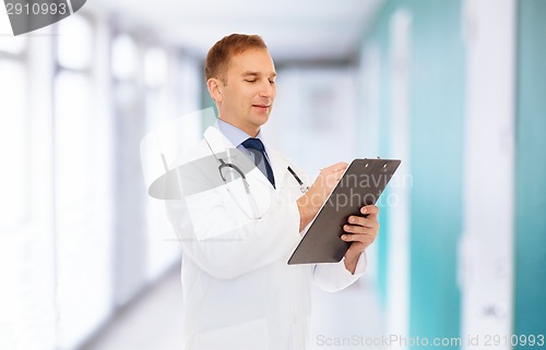 Image of smiling male doctor with clipboard and stethoscope