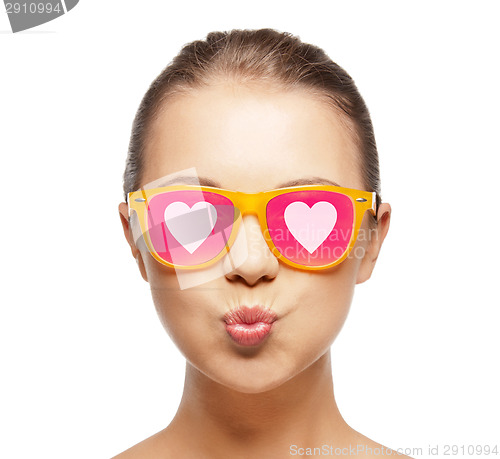 Image of girl in pink sunglasses blowing kiss