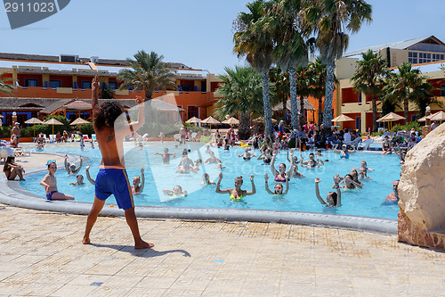 Image of Tourists on holiday are doing water aerobics in pool