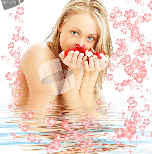 Image of blond with red and white rose petals and flowers in water