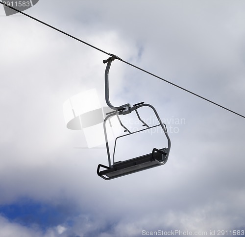 Image of Chair-lift and cloudy sky