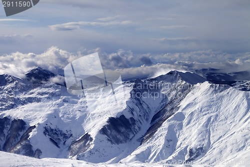 Image of Winter mountains in clouds at windy day