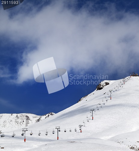 Image of Chair-lift and ski slope in sun day