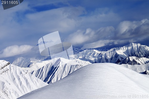 Image of Off-piste snowy slope and cloudy mountains