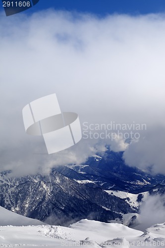 Image of Winter snowy mountains in clouds