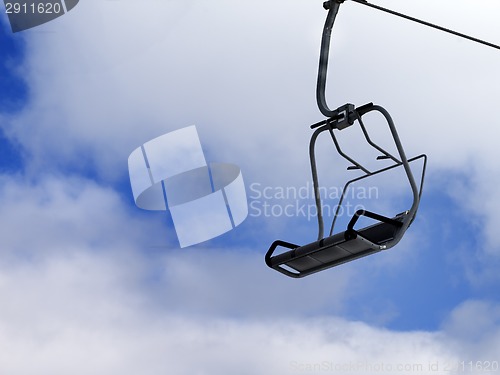 Image of Chair-lift and blue sky with clouds