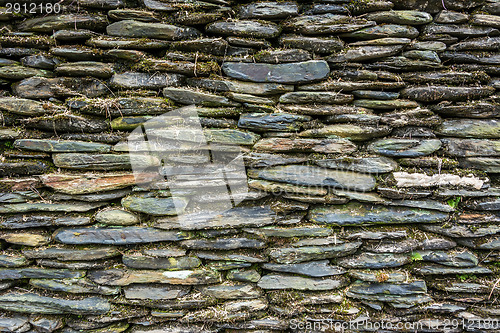 Image of Stone wall with green moss