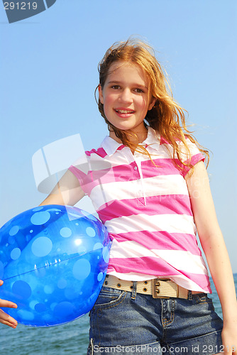 Image of Young girl with beach ball