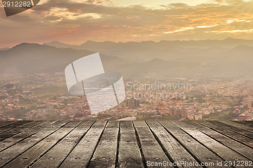Image of City sunset with wooden ground