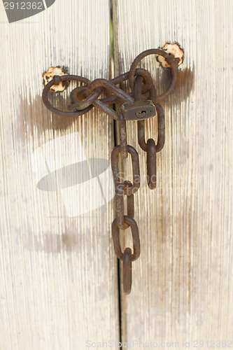 Image of Old door with lock and chain