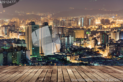 Image of City night scene with wooden ground