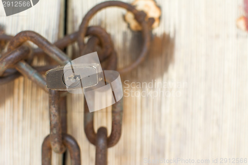 Image of Old door with lock and chain