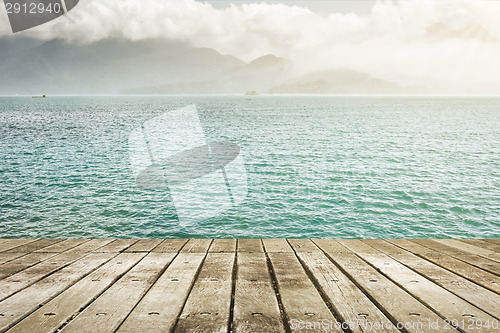 Image of lake with wooden ground