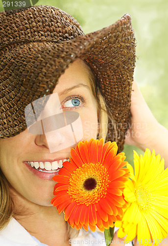 Image of attractive girl with straw hat and daisies