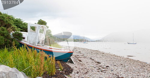 Image of Small shipwreck at a loch with stone beach