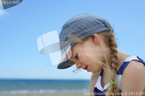 Image of Portrait of beautiful little girl in denim hat