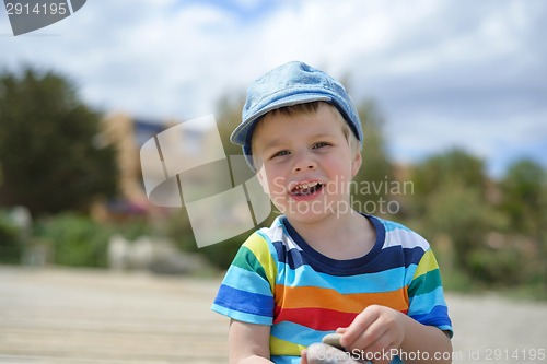 Image of Happy little boy in multicolored t-shirt