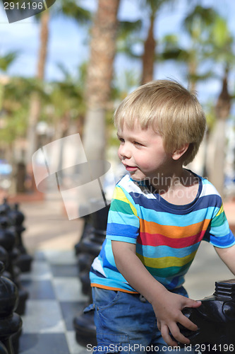 Image of Child playing with giant chess