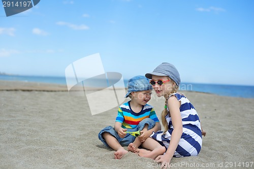 Image of Two small kids sitting on the beach