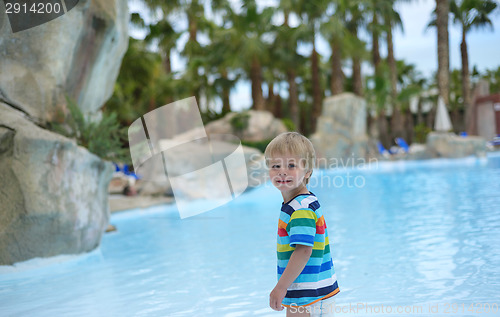 Image of Little baby boy near swimming pool