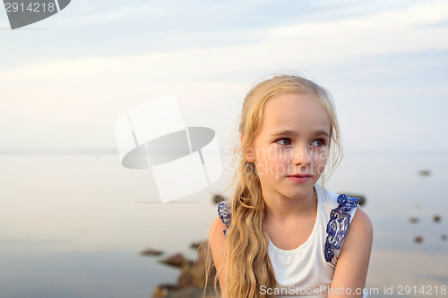 Image of Portrait of little girl on sunset