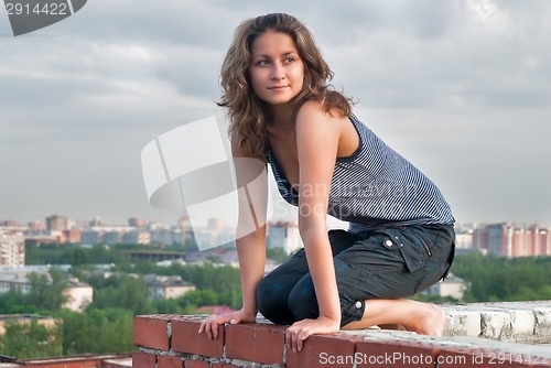 Image of Attractive girl on roof