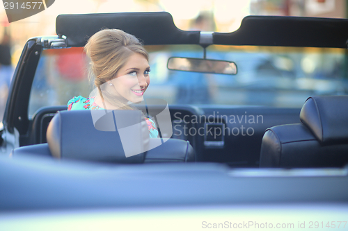 Image of Lovely Woman Posing and and Around a Vintage Car