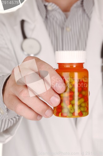 Image of Doctor With Medication in Prescription Bottles