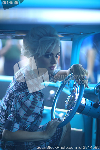 Image of Lovely Woman Posing and and Around a Vintage Car