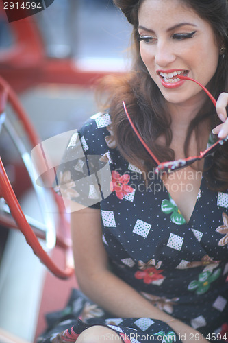 Image of Lovely Woman Posing and and Around a Vintage Car