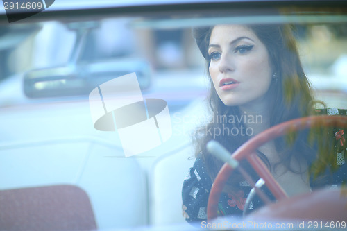 Image of Lovely Woman Posing and and Around a Vintage Car