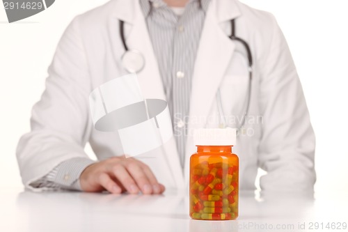 Image of Doctor With Medication in Prescription Bottles