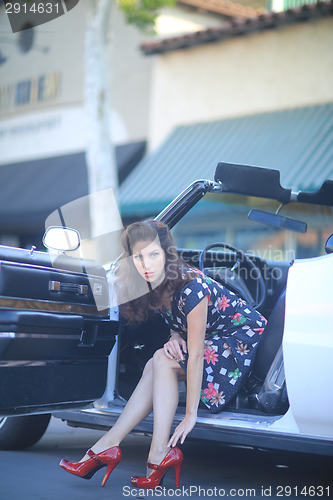 Image of Lovely Woman Posing and and Around a Vintage Car