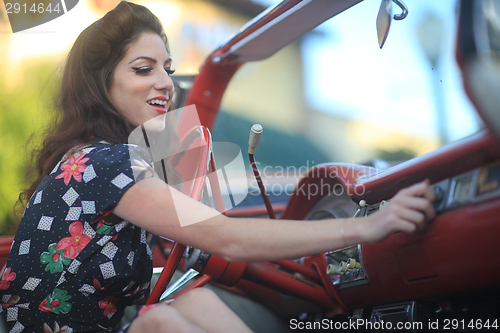 Image of Lovely Woman Posing and and Around a Vintage Car