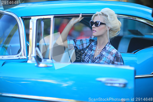 Image of Lovely Woman Posing and and Around a Vintage Car