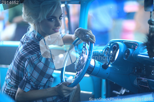 Image of Lovely Woman Posing and and Around a Vintage Car