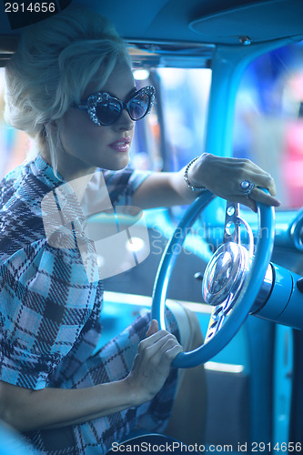 Image of Lovely Woman Posing and and Around a Vintage Car