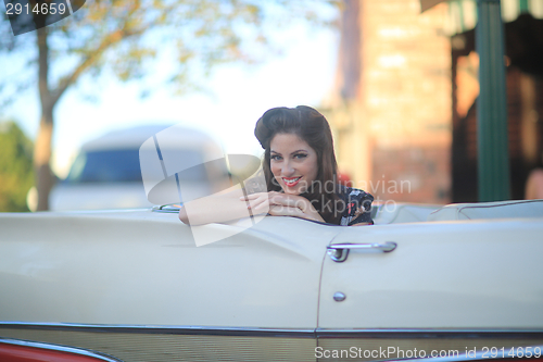 Image of Lovely Woman Posing and and Around a Vintage Car