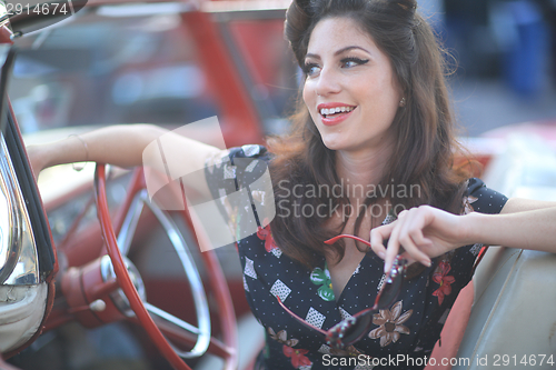 Image of Lovely Woman Posing and and Around a Vintage Car